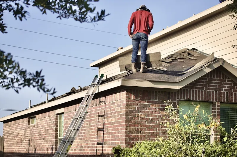 Professional roofer working on a residential roof in Vannoy Park